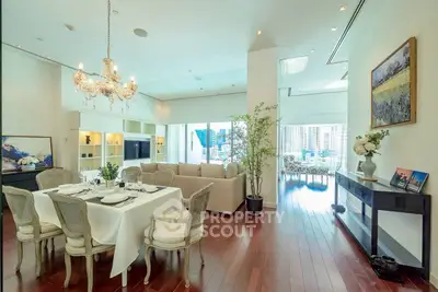 Luxurious open-plan living room with elegant dining area and city view.