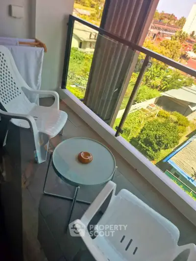 Charming balcony with seating and scenic view, perfect for relaxation and enjoying the outdoors.