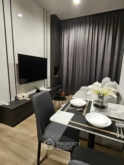 Modern living room with sleek furniture and elegant dining setup, perfect for urban living.