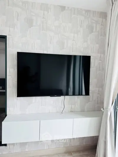 Modern living room with wall-mounted TV and sleek storage unit
