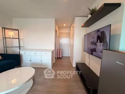Modern living room with sleek furniture and mounted TV, showcasing contemporary design.