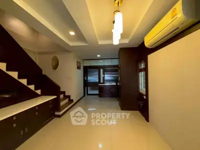 Spacious modern living room with elegant staircase and stylish lighting