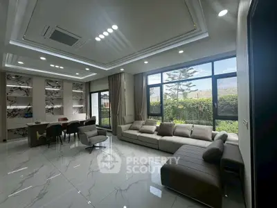 Luxurious modern living room with large windows and elegant marble flooring.