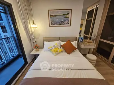 Cozy bedroom with modern decor and balcony view in a stylish apartment.