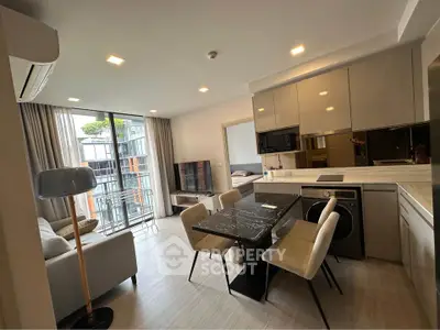 Modern open-plan living room with balcony in stylish apartment