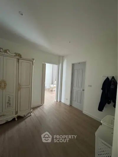 Spacious bedroom with elegant wardrobe and wooden flooring