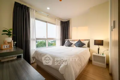 Spacious bedroom with large windows offering ample natural light, modern furnishings, and a serene ambiance perfect for relaxation.