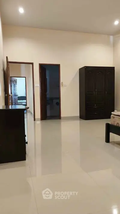 Spacious interior with polished floors and elegant wooden furniture, perfect for modern living.