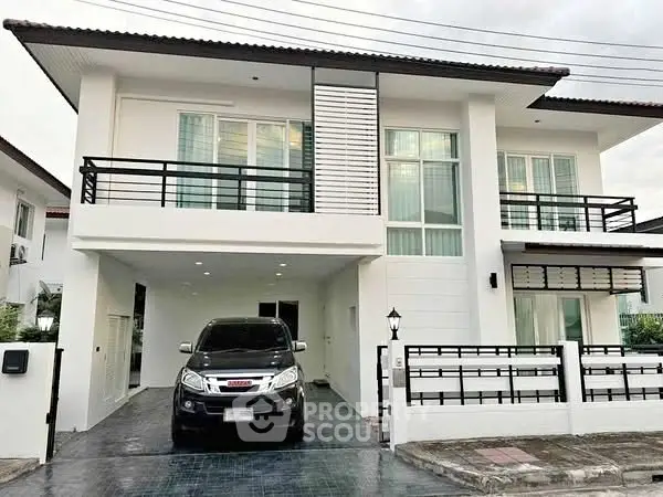 Modern two-story house with sleek design and spacious driveway