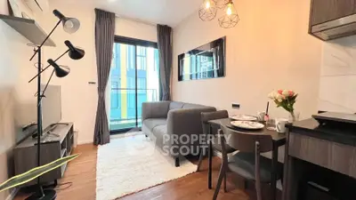 Modern living room with cozy sofa, stylish decor, and balcony view in urban apartment.