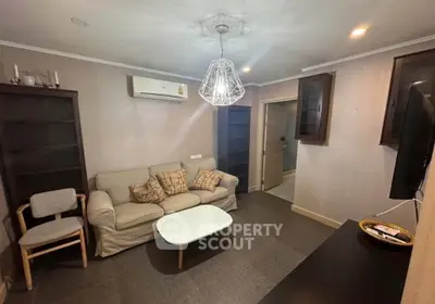 Cozy living room with modern lighting and comfortable seating, perfect for relaxation.