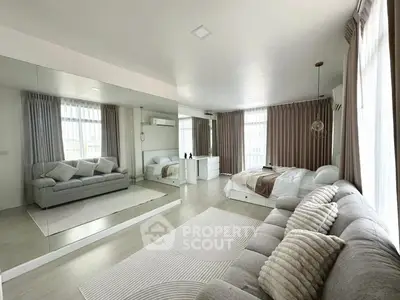 Spacious modern bedroom with large windows and stylish decor