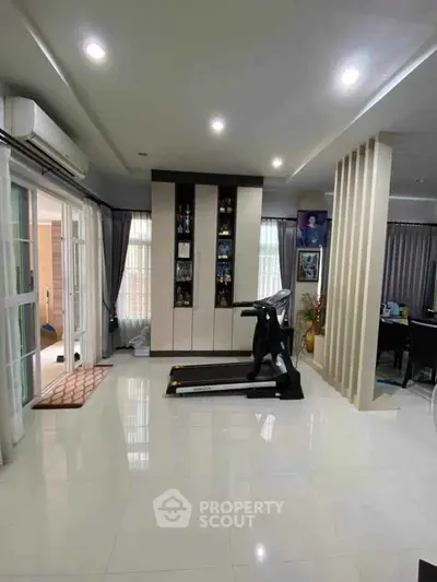 Spacious modern living room with treadmill and stylish decor