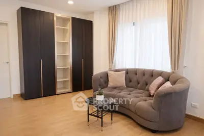 Elegant living room with stylish sofa and modern wardrobe, perfect for cozy relaxation.