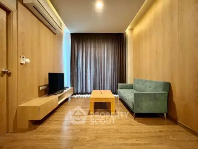 Modern living room with wooden flooring, stylish sofa, and entertainment unit.