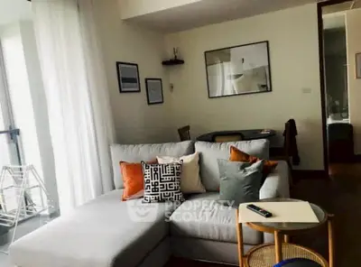 Stylish living room with modern decor and cozy seating area, perfect for relaxation and entertaining.