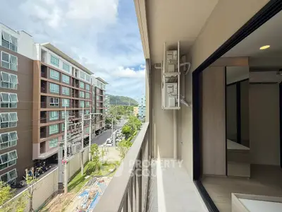 Modern apartment balcony with scenic city view and nearby buildings