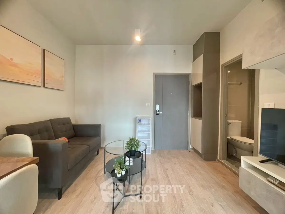 Modern living room with cozy sofa, stylish decor, and open layout