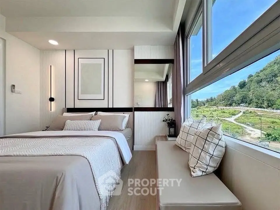 Modern bedroom with scenic view, large windows, and stylish decor in a cozy apartment.