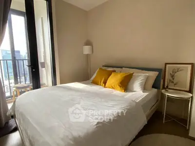 Cozy bedroom with balcony view and stylish decor in modern apartment.