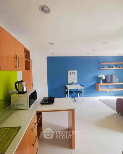 Modern kitchen with open layout and vibrant blue accent wall