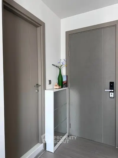 Modern apartment entrance with sleek elevator and stylish decor