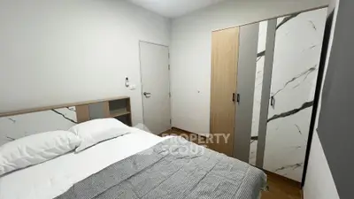 Modern bedroom with stylish wardrobe and cozy bed setup