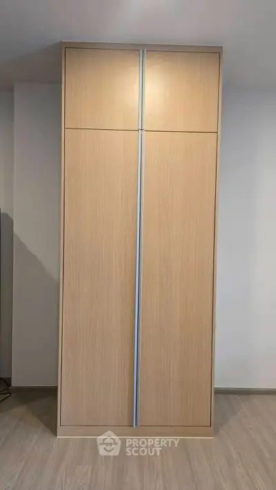 Modern wooden wardrobe with sleek design in a contemporary interior setting.