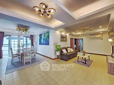 Spacious open-plan living and dining area with modern lighting and stylish decor.