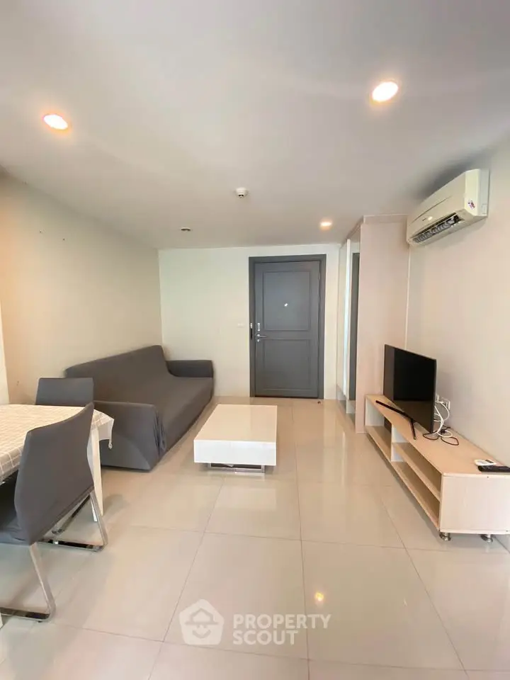 Modern living room with sleek furniture and air conditioning in a stylish apartment.