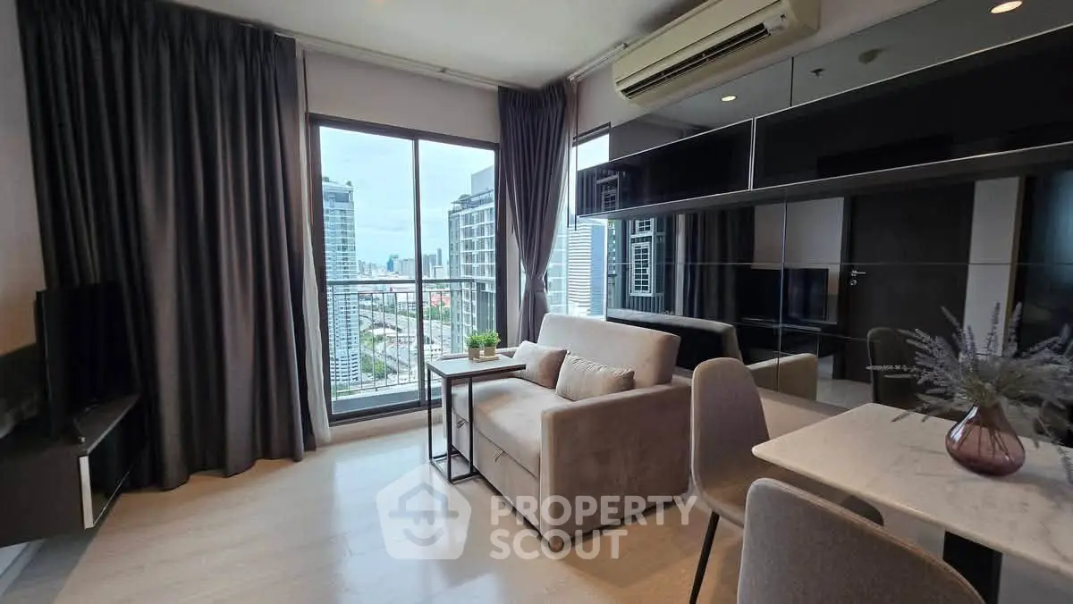 Modern living room with city view, featuring sleek furniture and large windows for natural light.