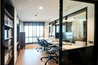 Modern study room with glass partition and sleek office furniture