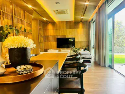 Luxurious modern living room with wooden accents and large windows offering a serene garden view.