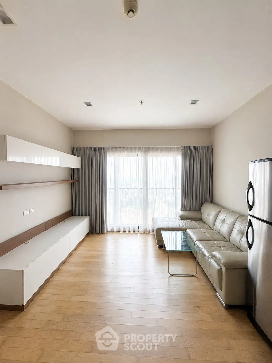 Spacious modern living room with natural light and sleek furniture
