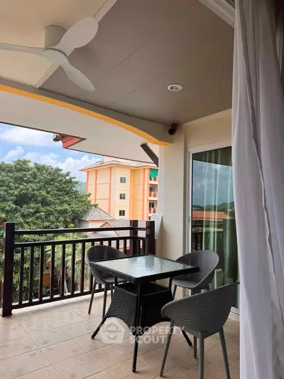 Spacious balcony with modern furniture and scenic view, perfect for relaxation and outdoor dining.