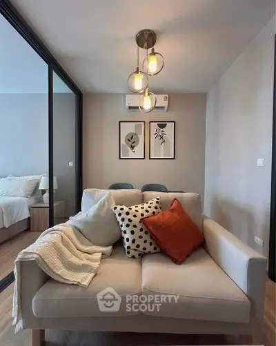 Modern living room with cozy sofa and stylish decor in a contemporary apartment.