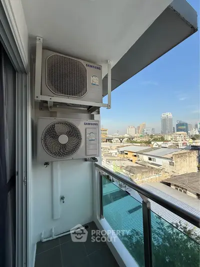 Modern balcony with city view and air conditioning units, perfect for urban living.
