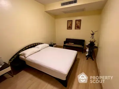 Cozy bedroom with modern decor and wooden flooring, perfect for relaxation and comfort.