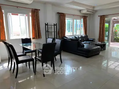 Spacious living room with modern furniture and large windows offering natural light.