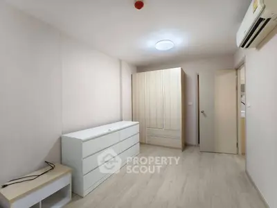 Spacious bedroom with modern wardrobe and air conditioning in minimalist design.