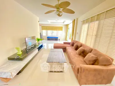Spacious living room with modern furniture and large windows for natural light.