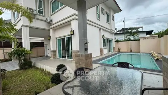 Modern house exterior with pool and patio, perfect for outdoor relaxation.