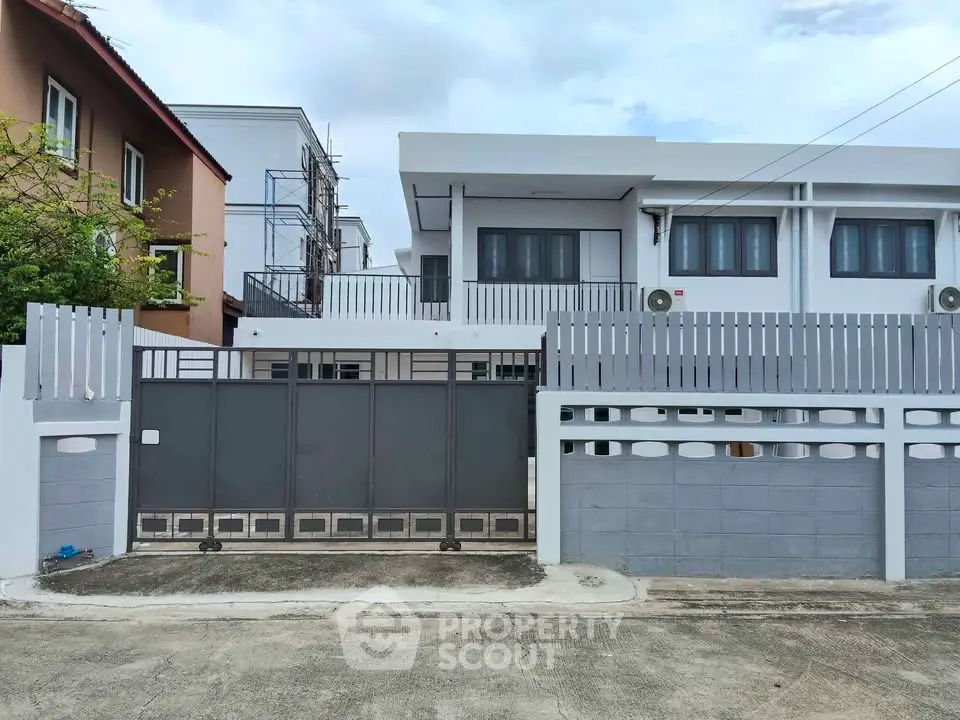 Modern townhouse exterior with gated entrance and sleek design