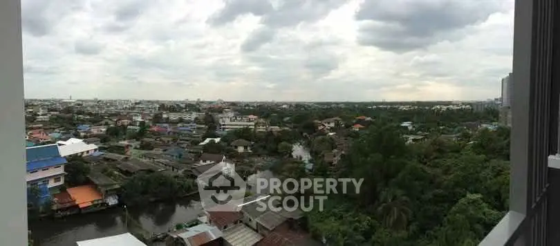 Panoramic cityscape view from high-rise building balcony showcasing urban and natural landscape.