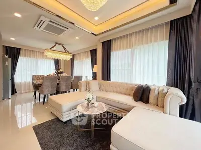 Luxurious living room with elegant dining area, plush seating, and ambient lighting for a sophisticated atmosphere.