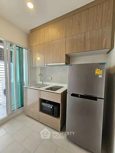 Modern compact kitchen with sleek cabinetry and stainless steel appliances