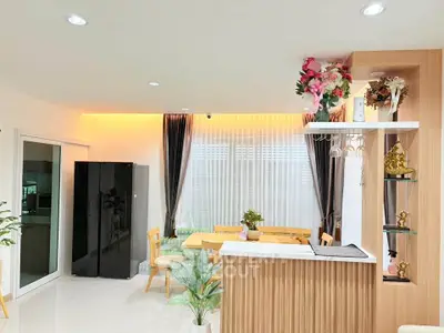 Modern living room with stylish decor and open layout, featuring elegant furniture and natural light.