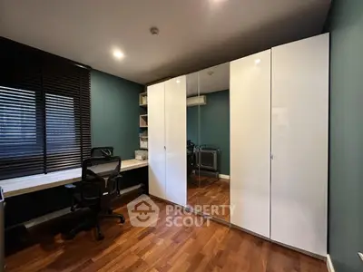Modern study room with sleek desk, ergonomic chair, and mirrored wardrobe