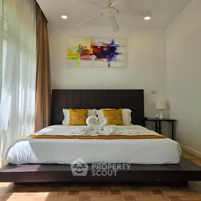 Luxurious bedroom with modern decor and elegant bedding in a stylish real estate property.