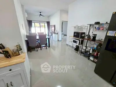 Modern open-layout kitchen and dining area with sleek appliances and stylish decor.